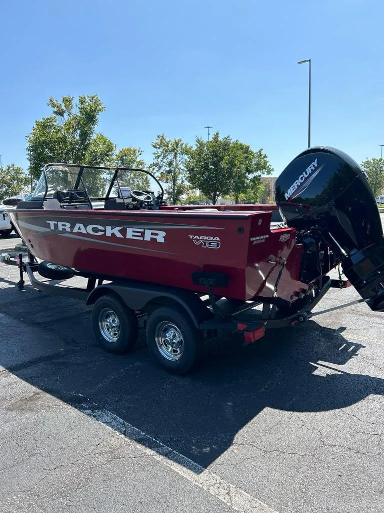 Slide: The Image of 2025 Tracker Targa V-19 Combo boat with Mercury engine, parked outdoors. - 3