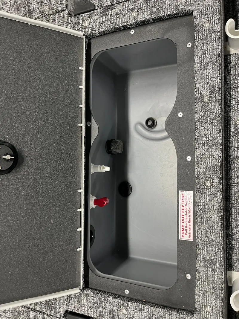 Slide: The Image of 2025 Tracker Targa V-19 Combo boat storage compartment with open lid. - 10