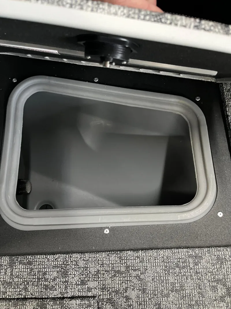 Slide: The Image of Storage compartment in 2025 Tracker Targa V-19 Combo boat, open lid view. - 11