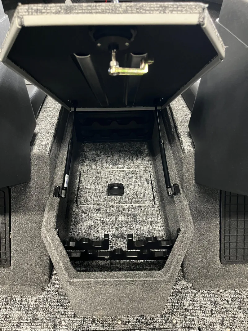 Slide: The Image of 2025 Tracker Targa V-19 Combo boat storage compartment with open lid, showcasing interior space. - 12