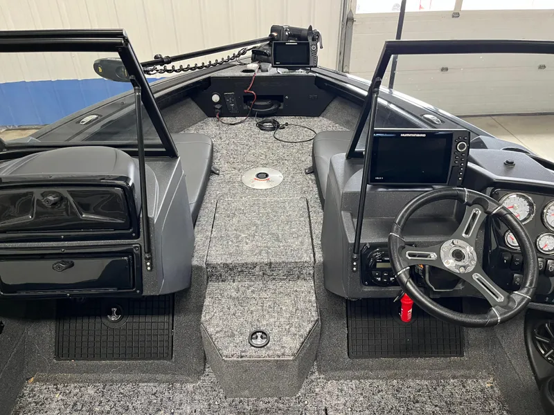 Slide: The Image of 2025 Tracker Targa V-19 Combo boat interior with steering wheel and control panel. - 13