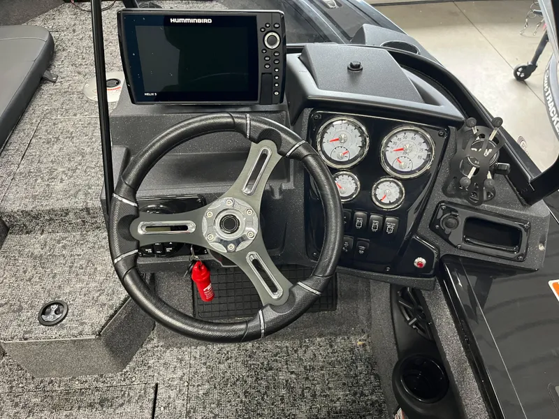 Slide: The Image of 2025 Tracker Targa V-19 Combo dashboard with steering wheel and Humminbird fish finder. - 18
