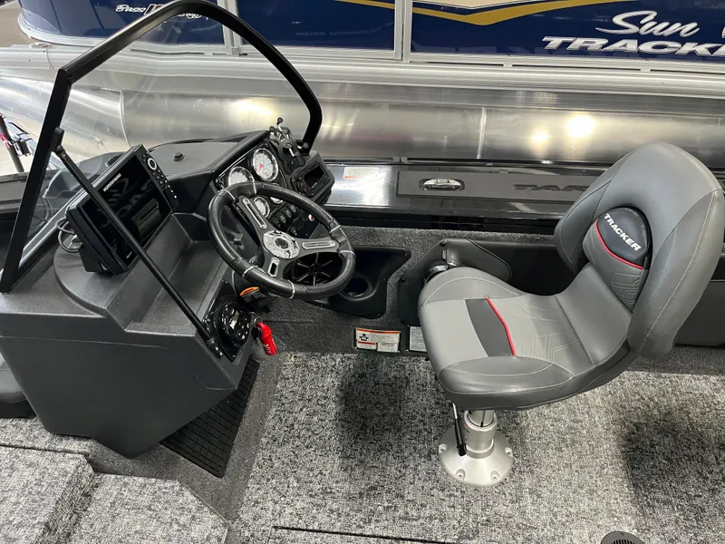 Slide: The Image of 2025 Tracker Targa V-19 Combo boat interior with steering console and seat. - 19