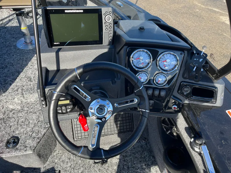 Slide: The Image of 2025 Tracker Targa V-19 Combo boat dashboard with steering wheel and electronic display. - 20