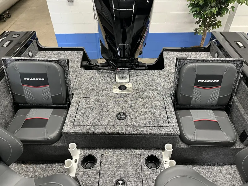 Slide: The Image of 2025 Tracker Targa V-19 Combo boat interior with gray seating and storage compartments. - 3