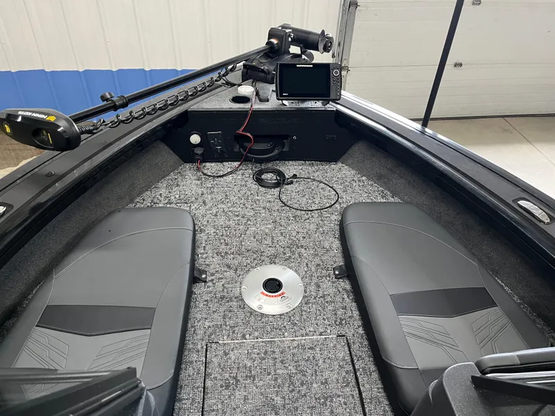 Slide: The Image of 2025 Tracker Targa V-19 Combo boat interior with seating and navigation equipment. - 7