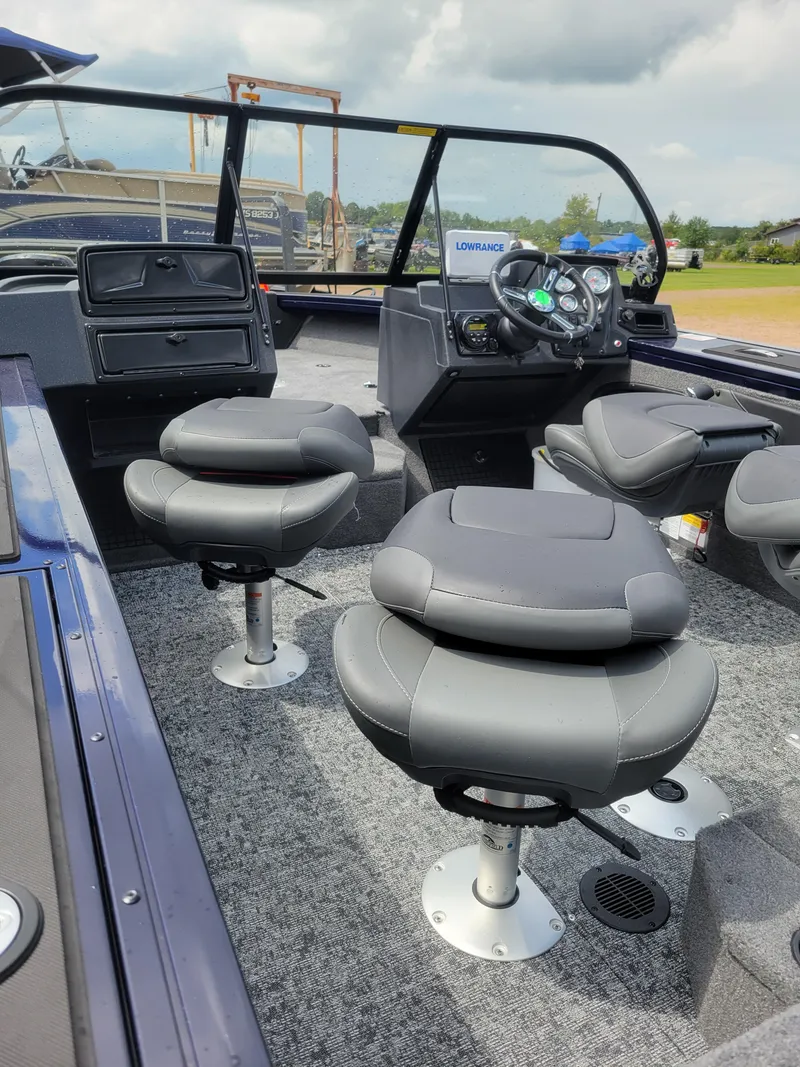 Slide: The Image of 2025 Tracker Targa V-19 WT boat interior with gray seating and modern dashboard. - 5