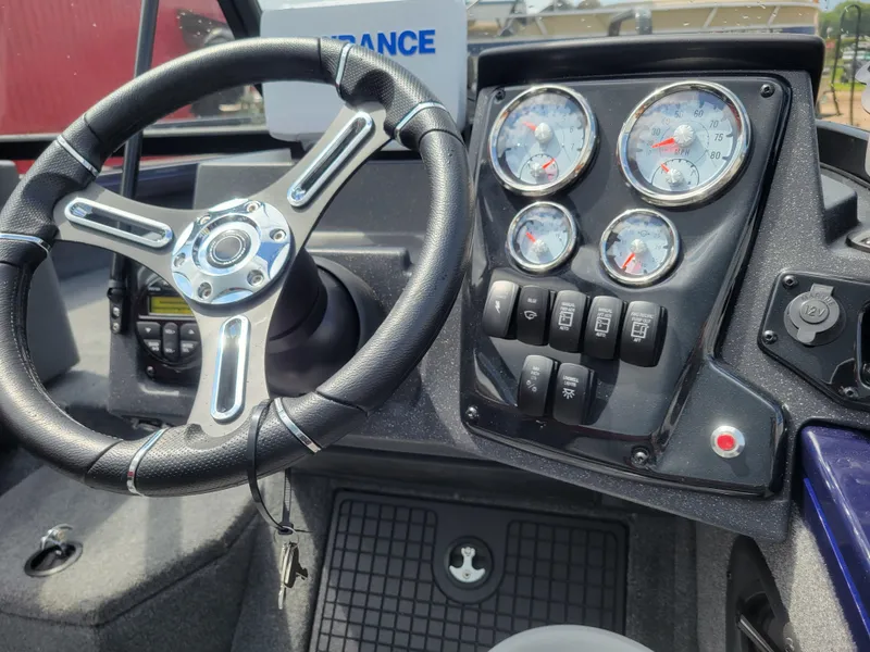 Slide: The Image of 2025 Tracker Targa V-19 WT dashboard with steering wheel and instrument panel. - 6