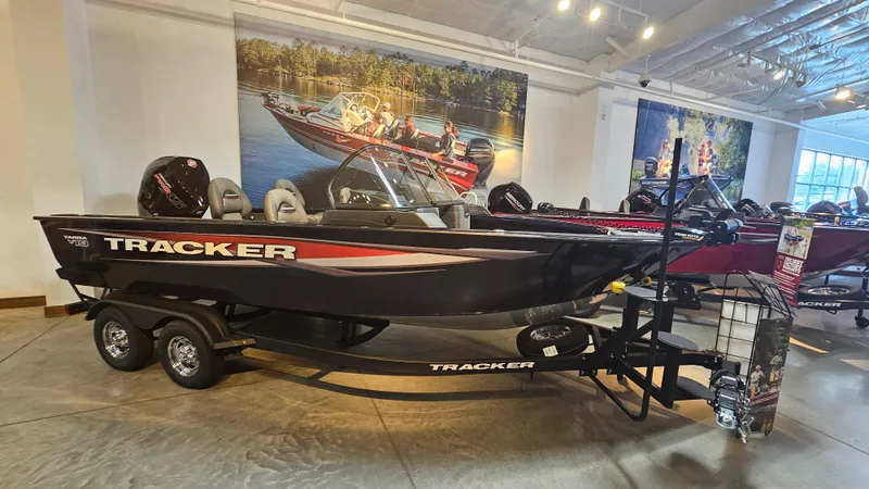The Image of 2025 Tracker Targa V-19 WT boat displayed in showroom with trailer. - 0
