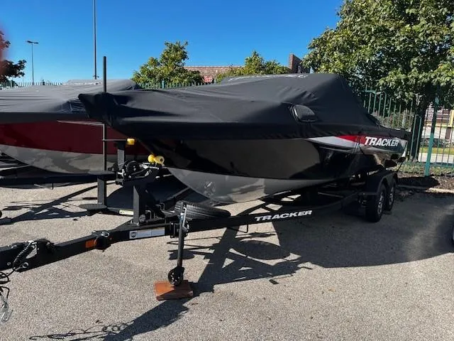 Slide: The Image of 2025 Tracker Targa V-19 Combo boat on trailer, covered, parked outdoors. - 4