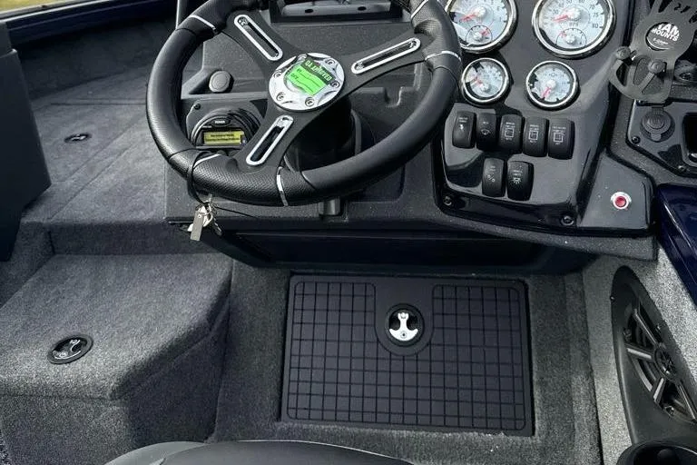 Slide: The Image of 2025 Tracker Targa V-19 WT boat dashboard with steering wheel and instrument panel. - 14