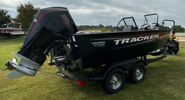Slide: The Image of 2025 Tracker Targa V-19 WT boat on trailer, parked on grass. - 6