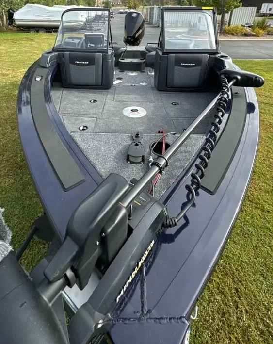 Slide: The Image of 2025 Tracker Targa V-19 WT fishing boat on grass, featuring spacious deck and modern equipment. - 8