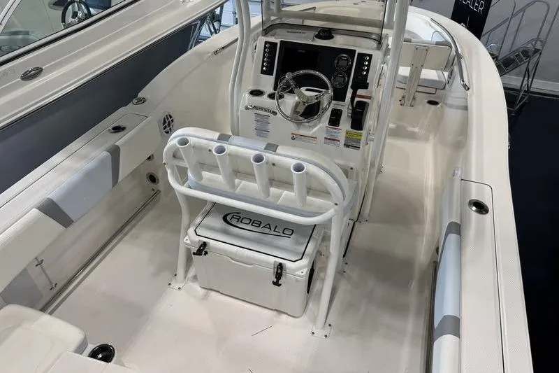 Slide: The Image of 2025 Robalo R 200 CC boat interior with steering console and seating. - 12