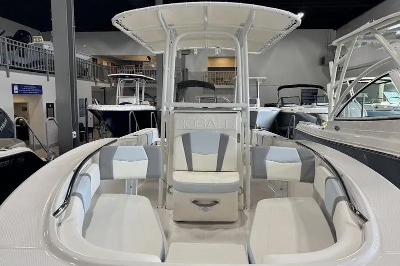 Slide: The Image of 2025 Robalo R 200 CC boat interior with seating and console, displayed in showroom. - 4