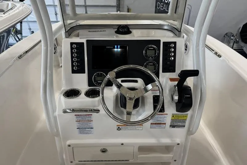 Slide: The Image of 2025 Robalo R 200 CC boat dashboard with steering wheel and control panel. - 6