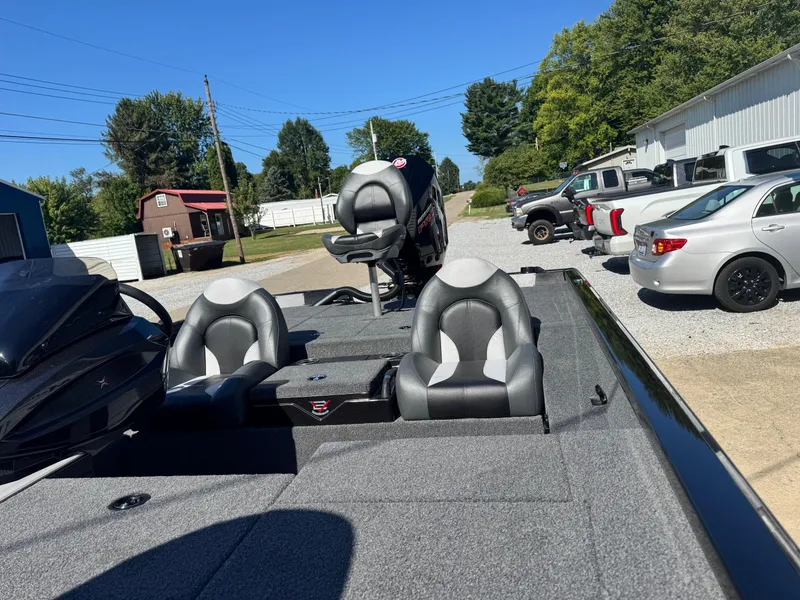 Slide: The Image of 2025 Vexus AVX2080 boat with dual seats and motor, parked outdoors on a sunny day. - 9