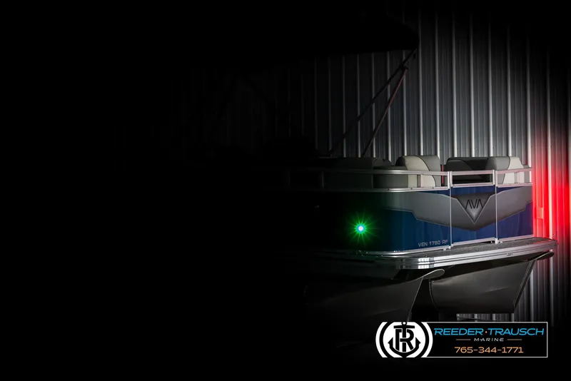 Slide: The Image of 2025 Avalon VEN RF boat in dimly lit storage, featuring sleek design and green navigation light. - 4