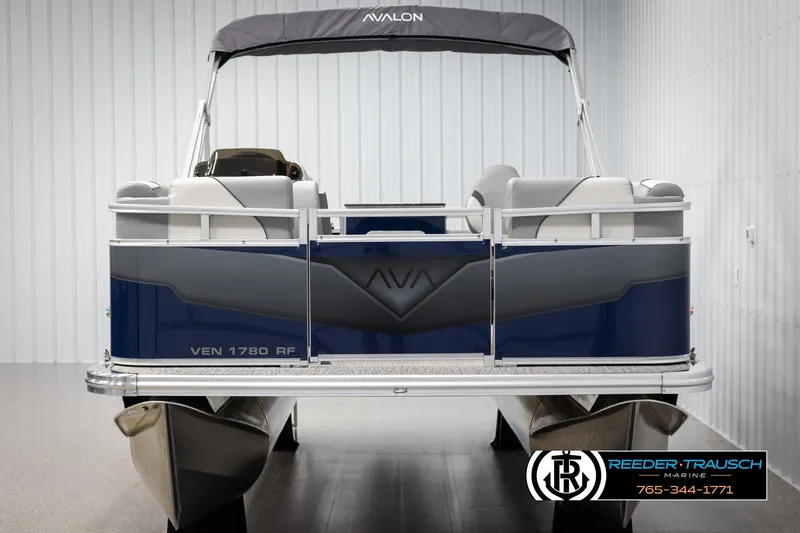 Slide: The Image of 2025 Avalon VEN RF pontoon boat, blue and gray, rear view in showroom. - 8