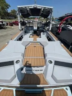 Slide: The Image of 2024 Nautique GS24 boat with sleek design and spacious interior. - 11
