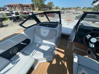 Slide: The Image of 2024 Nautique GS24 boat interior with modern seating and steering wheel. - 14