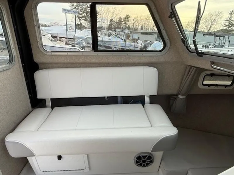 Slide: The Image of 2025 Parker 2120 Sport Cabin interior with white seating and window view. - 13
