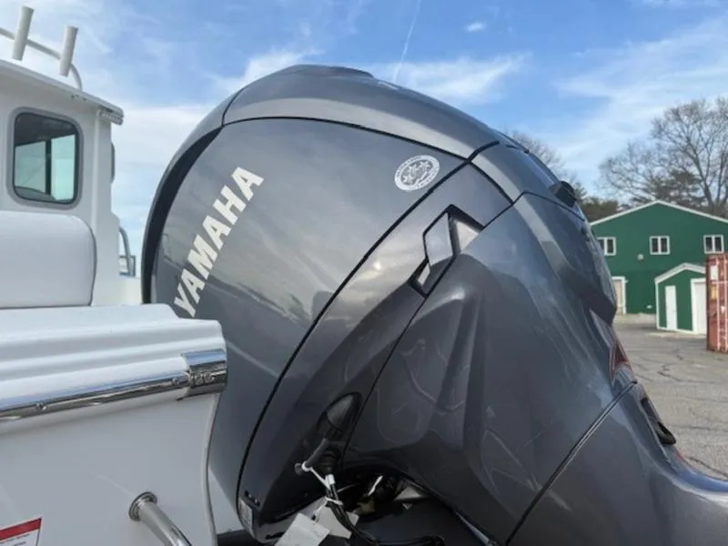 Slide: The Image of Yamaha outboard motor on 2025 Parker 2120 Sport Cabin boat, docked outdoors. - 7