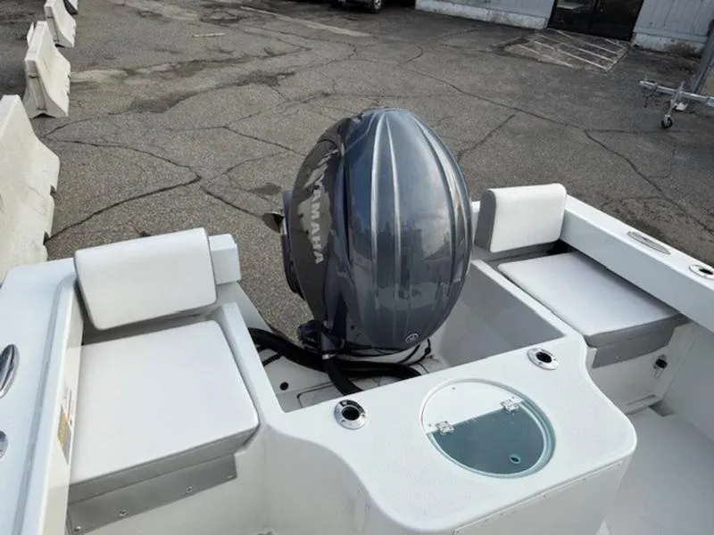 Slide: The Image of 2025 Parker 2120 Sport Cabin boat with Yamaha outboard motor, docked on concrete surface. - 8