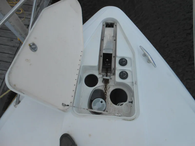 Slide: The Image of Open anchor locker on 2004 Formula 37 PC boat, showing chain and storage compartments. - 11