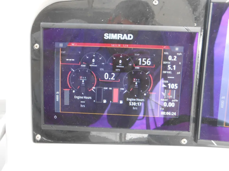 Slide: The Image of Simrad display on 2004 Formula 37 PC showing engine metrics and navigation data. - 19