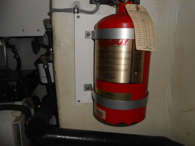 Slide: The Image of Fire extinguisher mounted on a 2004 Formula 37 PC boat interior wall. - 28