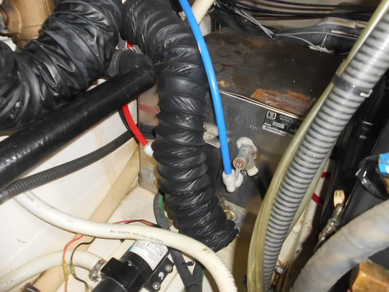 Slide: The Image of Engine compartment of a 2004 Formula 37 PC boat, showing hoses and wiring. - 29