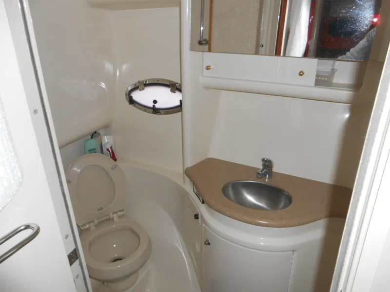 Slide: The Image of 2004 Formula 37 PC yacht bathroom with sink, toilet, and porthole window. - 8