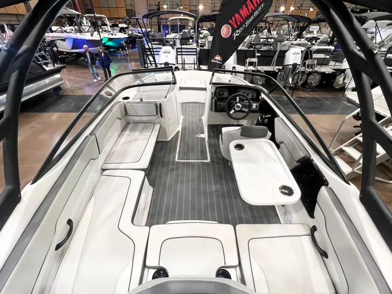 Slide: The Image of 2025 Yamaha Boats AR190 interior with seating and steering wheel, showcased at a boat exhibition. - 2