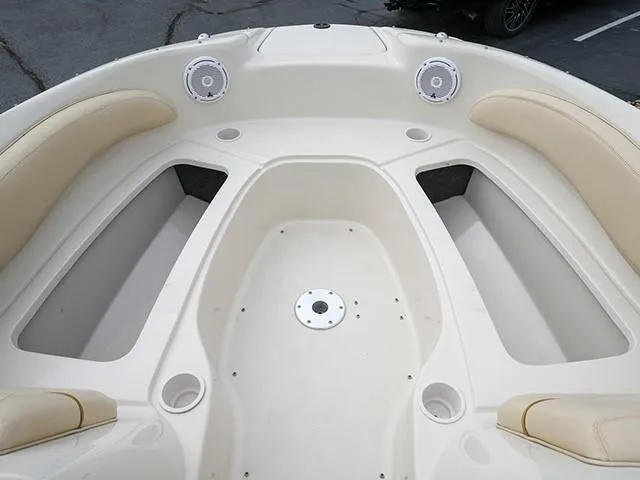 Slide: The Image of 2001 Sea Ray 190 Sundeck boat interior with beige seating and cup holders. - 11