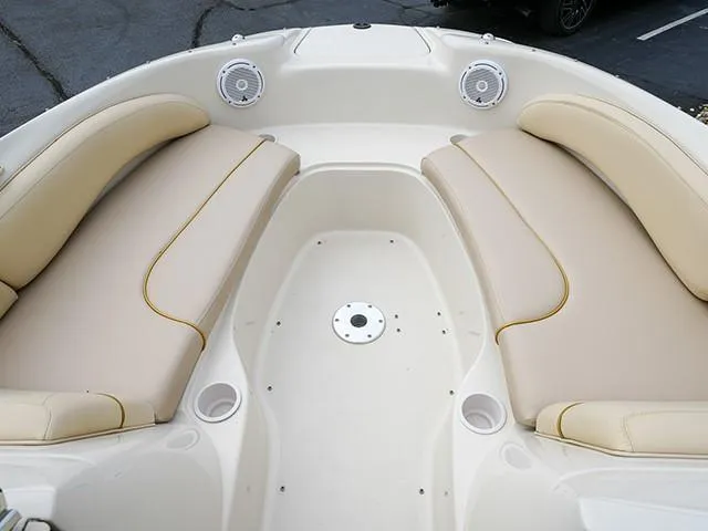 Slide: The Image of 2001 Sea Ray 190 Sundeck interior with beige seating and built-in speakers. - 12