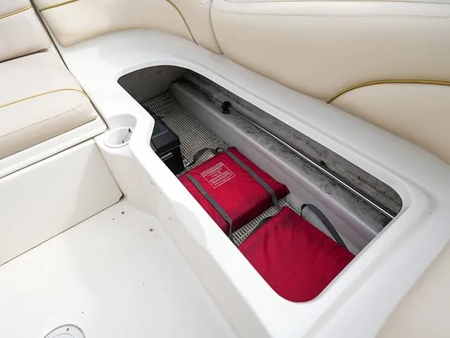 Slide: The Image of Storage compartment in a 2001 Sea Ray 190 Sundeck boat with red life jackets. - 13