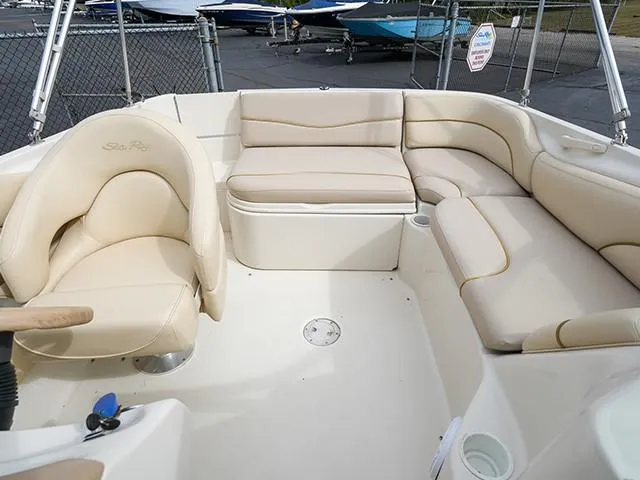 Slide: The Image of 2001 Sea Ray 190 Sundeck boat interior with beige seating and steering wheel. - 7