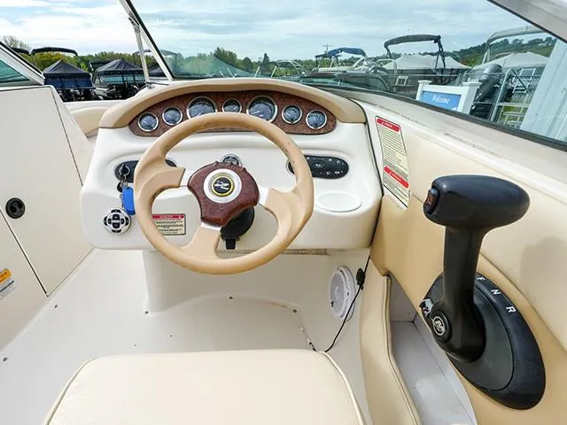 Slide: The Image of 2001 Sea Ray 190 Sundeck boat dashboard with steering wheel and control panel. - 9