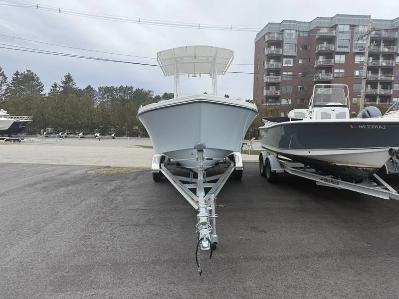 Slide: The Image of 2025 Parker 21 SE CC boat on trailer, parked outdoors near other boats. - 5