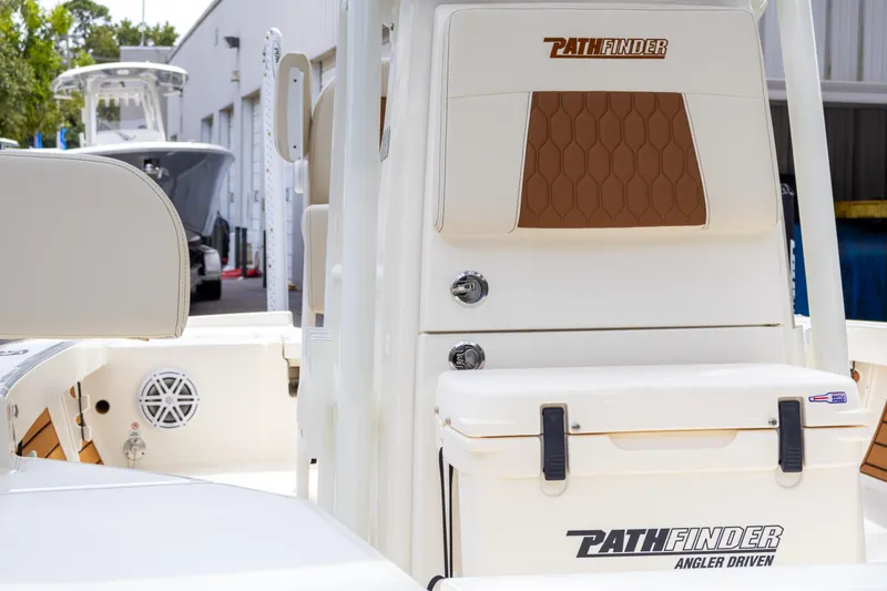 Slide: The Image of 2025 Pathfinder 2200 TRS boat interior with branded cooler and seating. - 13