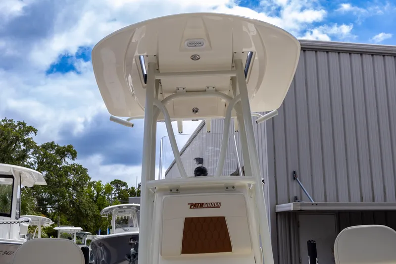 Slide: The Image of 2025 Pathfinder 2200 TRS boat with T-top, viewed from below, against a cloudy sky. - 15
