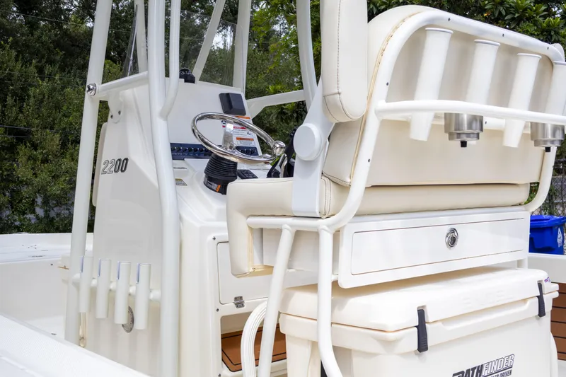 Slide: The Image of 2025 Pathfinder 2200 TRS boat interior with steering console and seating. - 16