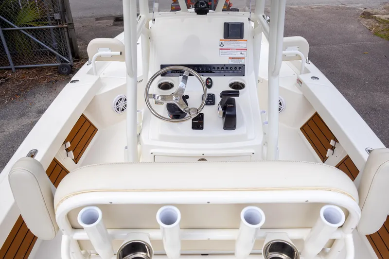 Slide: The Image of 2025 Pathfinder 2200 TRS boat interior with steering wheel and rod holders. - 18
