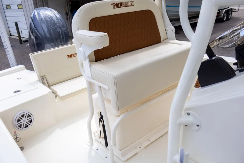 Slide: The Image of 2025 Pathfinder 2200 TRS boat interior with cushioned seating and storage. - 19