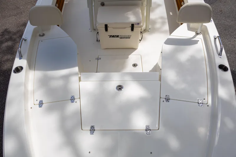 Slide: The Image of 2025 Pathfinder 2200 TRS boat deck with seating and storage compartments. - 22