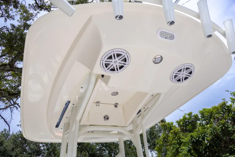 Slide: The Image of 2025 Pathfinder 2200 TRS boat T-top with speakers and rod holders. - 24