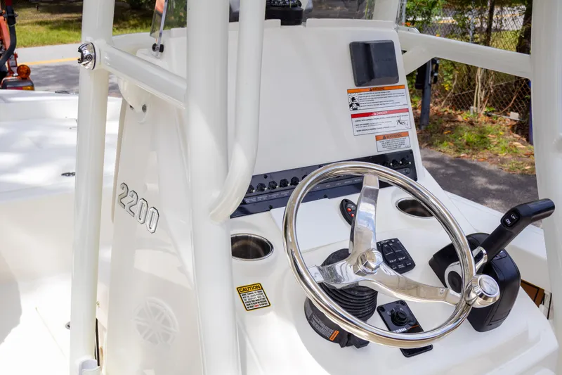 Slide: The Image of 2025 Pathfinder 2200 TRS boat console with steering wheel and controls. - 25
