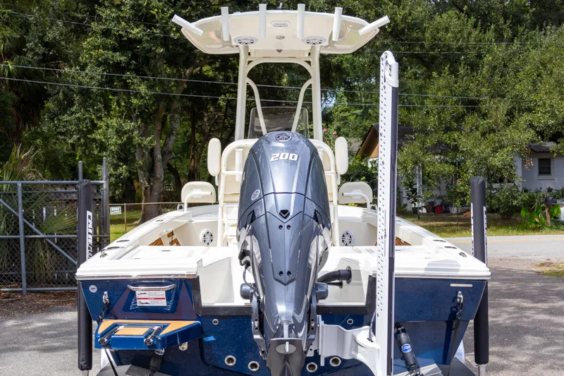 Slide: The Image of 2025 Pathfinder 2200 TRS boat with powerful outboard motor, parked outdoors. - 5