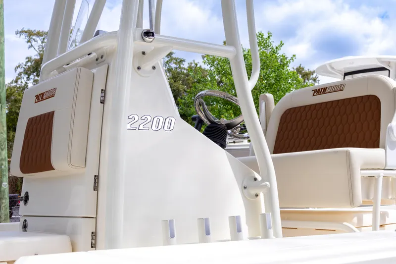Slide: The Image of 2025 Pathfinder 2200 TRS boat interior with seating and steering wheel. - 8